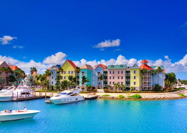 Colorful waterfront buildings and yachts in the Bahamas under a bright blue sky